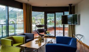 a room with chairs and a table and a large window at Havila Hotel Ivar Aasen in Ørsta