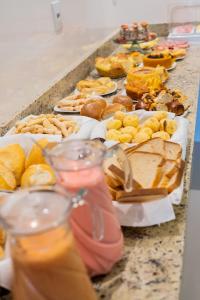 a table topped with lots of different types of food at Nico Palace Hotel in Guanambi