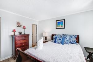 a bedroom with a bed and a dresser at Oceanside 301-A in Isle of Palms