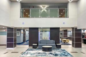 an office lobby with a couch and a table at Wingate by Wyndham Panama City Area Lynn Haven in Panama City