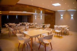 a restaurant with tables and chairs in a room at Harmony Hotel in Ipiales