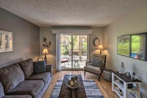 a living room with a couch and a table at Condo with Balcony - Walk to Lake, Dining, and Shops! in Lake Havasu City