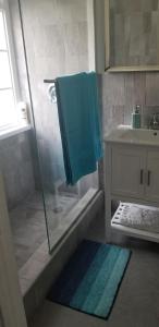 een badkamer met een douche en een blauwe handdoek bij Apartment Treasure at Sandcastles in Ocho Rios