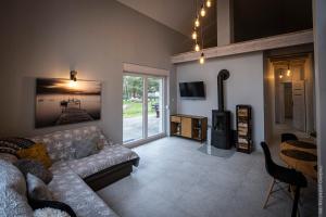 a living room with a couch and a fireplace at DOM LETNI Nakielno in Nakielno
