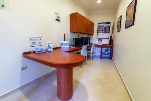 a kitchen with a wooden table in a room at Best Western Taxco in Taxco de Alarcón