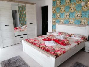a bedroom with a large bed with flowers on it at Casa Iris Murighiol in Murighiol +67 photos