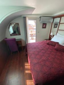 a bedroom with a large red bed and a window at Dareyn Hotel in Istanbul