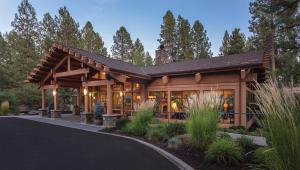 a home in the woods with a gambrel roof at Seventh Mountain Resort in Bend