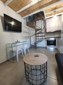 a living room with a spiral staircase and a table at Wish Sea & Mountain View in Stalos