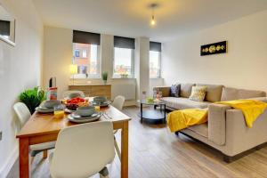 a living room with a couch and a table at Modern & Stylish 2BR Apartment - Queens House in Coventry