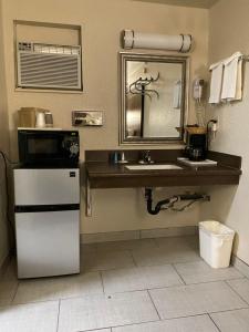 a kitchen with a sink and a mirror and a refrigerator at Motel In The Pines in Munds Park +37 photos