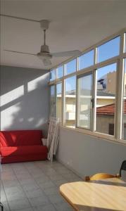 a living room with a red couch and windows at Casa America in Montesilvano Marina