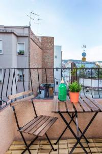 a table on a balcony with a green container on it at Pleasant Studio with Balcony Close to Camp Nou in Hospitalet de Llobregat