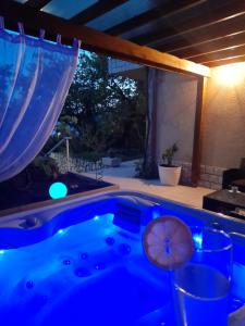 a jacuzzi tub in a backyard with a window at Villa deluxe "H" - private jacuzzi in Novi Vinodolski