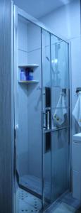 a shower with a glass door in a bathroom at Apartament Dla Dwojga in Ustrzyki Dolne