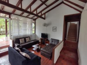 a living room with a couch and a tv at CASA QUINTA BENDITO PARAÍSO in Melgar