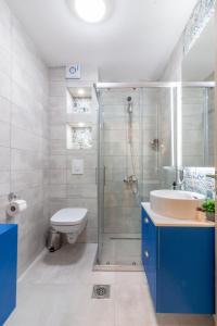 a bathroom with a shower and a sink and a toilet at Blue Lake Apartments in Ohrid