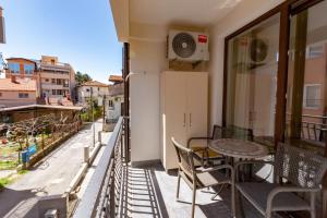 a balcony with a table and chairs and a view at Blue Lake Apartments in Ohrid