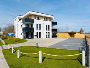 a large white building with a playground in front of it at Haus Meerruhe Karlshagen Apartment 7 in Ostseebad Karlshagen