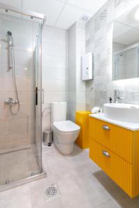 a bathroom with a toilet and a sink and a shower at Blue Lake Apartments in Ohrid