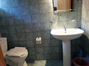 a bathroom with a sink and a toilet at Plataria Palace in Plataria