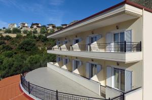 a building with balconies on the side of it at Plataria Palace in Plataria