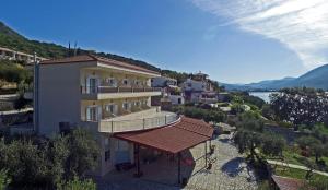 a building with a balcony and a view of a river at Plataria Palace in Plataria