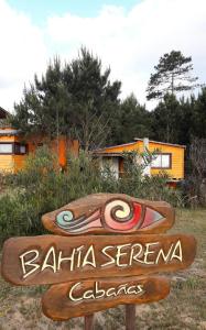 a sign for a barilla serrano calaza with a house at Cabañas Bahia Serena in Punta Del Diablo