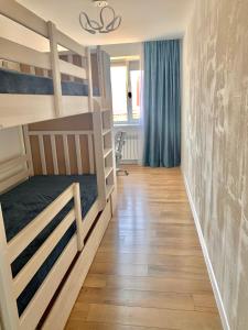 a room with two bunk beds and a hallway at Park Lake Апартаменти Центр in Ternopilʼ