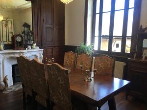 a dining room with a wooden table and chairs at Lime trees in Arnac-Pompadour