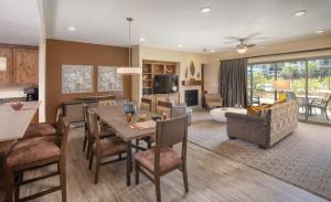 a living room with a table and a dining room at WorldMark Estancia in St. George