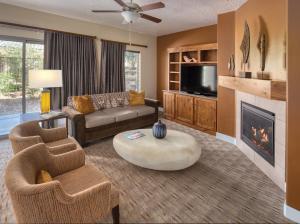 a living room with a couch and a fireplace at WorldMark Estancia in St. George
