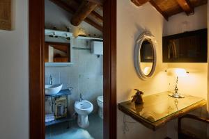 a bathroom with a sink and a toilet and a mirror at CENTRAL- VIEWS - AIR CONDITIONING - Easy Parking -SELF CHECK In in Perugia