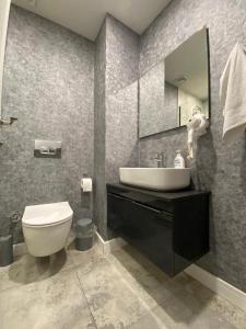 a bathroom with a sink and a toilet and a mirror at Kent Suit Otel in Istanbul +37 photos