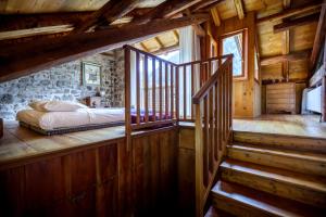 a bedroom with a bed and stairs in a cabin at LA PITA AGORDINA in Cancellade