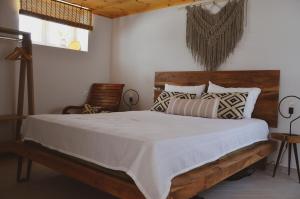 a bedroom with a large bed with white sheets and pillows at Samothrakis Michelangelo 101 Luxury apartment in Samothraki
