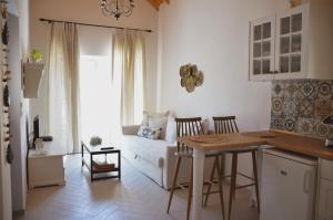 a kitchen and living room with a table and a couch at Samothrakis Michelangelo 101 Luxury apartment in Samothraki