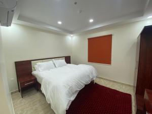 Een bed of bedden in een kamer bij لحظة الاحلام للشقق الفندقية