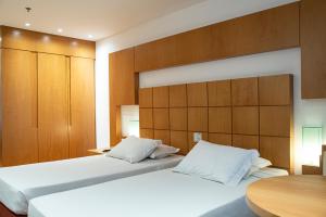 Postel nebo postele na pokoji v ubytování Mar Palace Copacabana Hotel