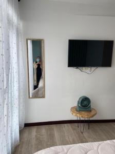 a living room with a flat screen tv on a wall at Apto 307 Metroloft Armenia in Armenia