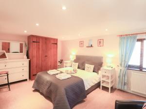 a bedroom with a bed with two towels on it at Hayloft Cottage in Wigton