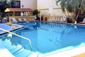 a large swimming pool with chairs in a hotel at Bay Oaks C 2nd Floor in Siesta Key