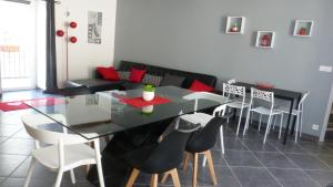 a dining room with a glass table and chairs at La Pause Ardéchoise in Saint-Remèze +3 photos