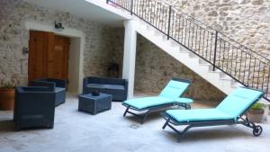 a patio with two chairs and a staircase at La Pause Ardéchoise in Saint-Remèze
