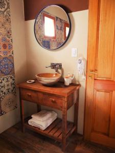 a bathroom with a bowl sink and a mirror at Tierra Quebrada Cabañas in Purmamarca +121 photos