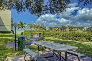 a picnic table and benches in a park at Bay Oaks C 2nd Floor in Siesta Key