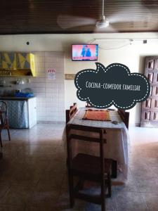 a restaurant with a table with a cloud sign on it at Posada MARTINEZ in Corrientes
