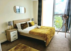 a bedroom with a bed and a large window at Blue Diamond in Milton Keynes