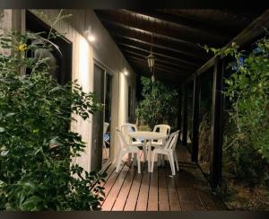 a patio with a table and chairs on a porch at Cabañas del Este in Sauce de Portezuelo