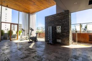 a gym with a brick wall and some exercise equipment at Cozy High End Studio in heart of Palermo Soho -T105- in Buenos Aires